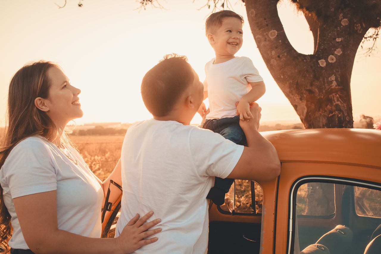 A joyful family spending quality time together outdoors at sunset.